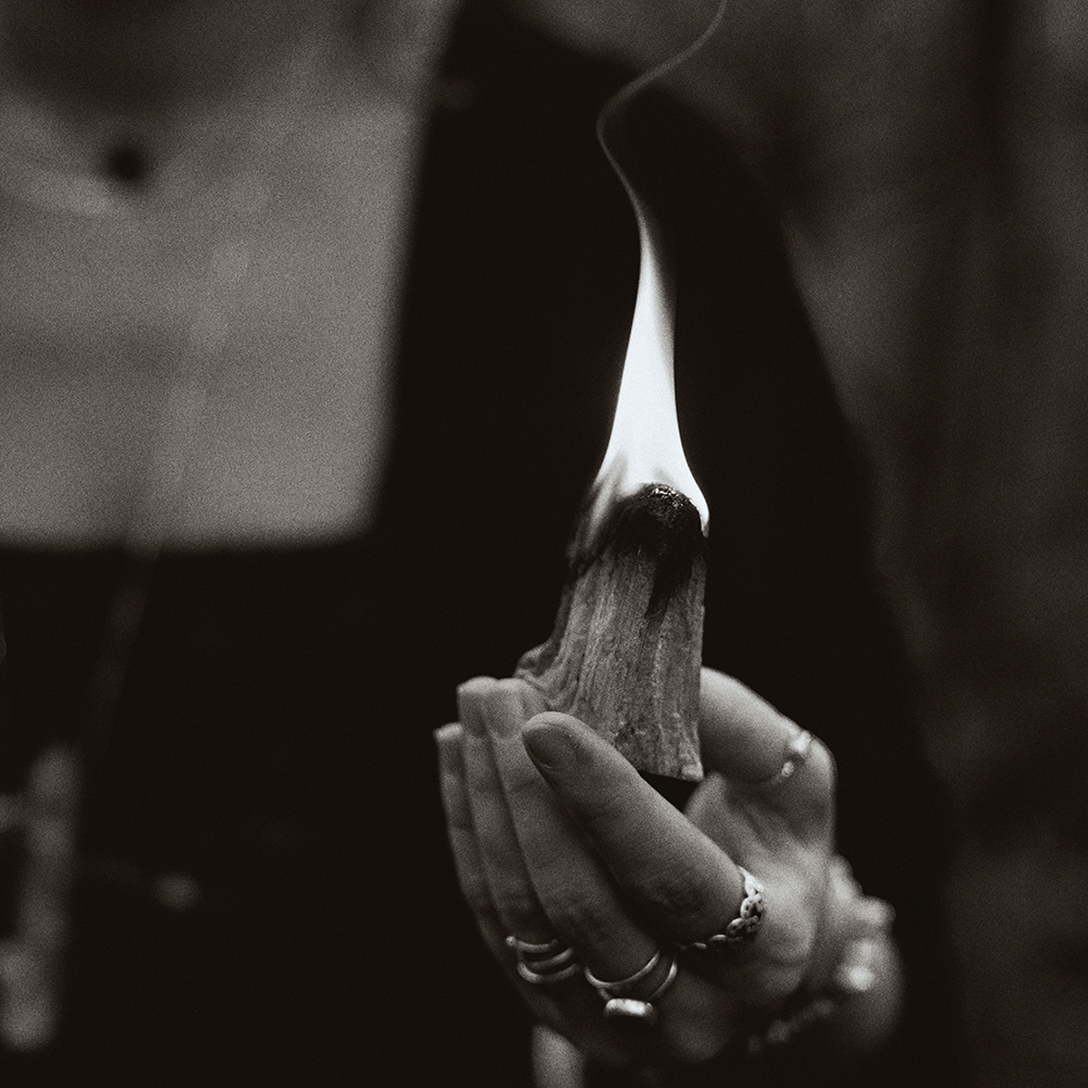 A serene scene of Palo Santo incense gently smoldering, releasing its distinctive soothing scent for spiritual renewal and mindfulness.