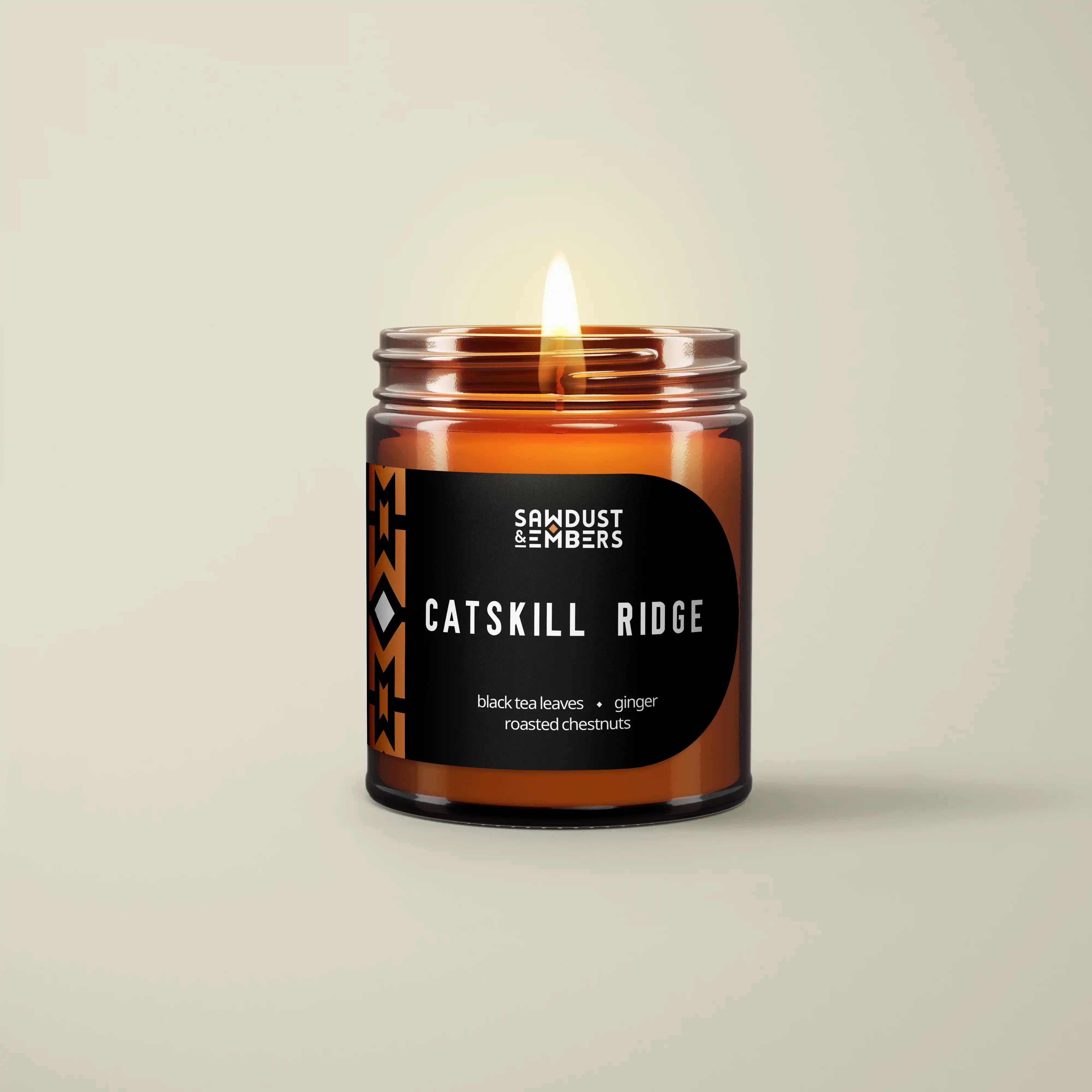 Catskill Ridge black tea and roasted chestnut candle in an amber glass jar by Sawdust & Embers.