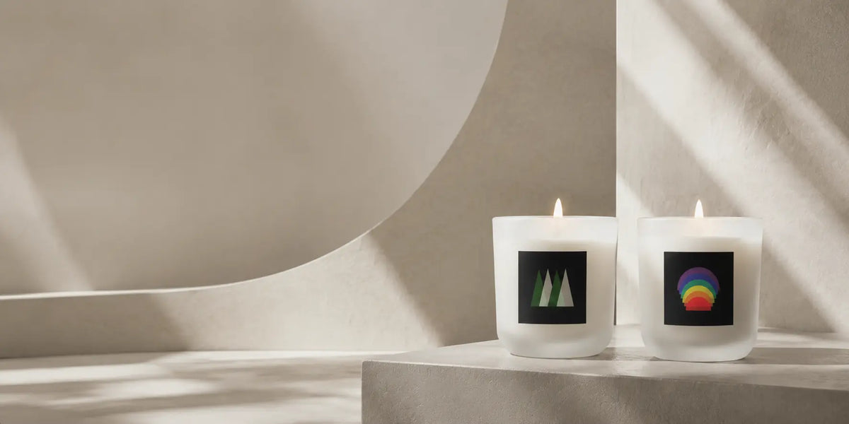 Two lit Ethereal Journeys candles arranged in soft light with pale architectural forms